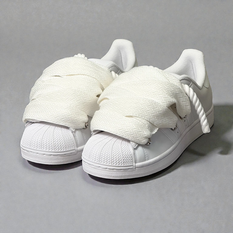 Side angle of Triple White Adidas Superstar with 1.0 white rope base and white Lanvin fat laces