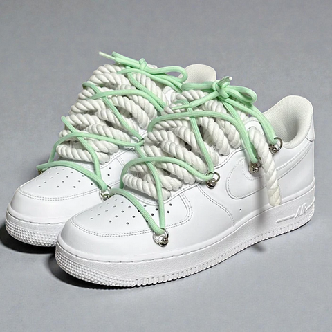 High-contrast White AF1 showcasing 1.0 white rope laces and a lime green "Off-White" style overlay.
