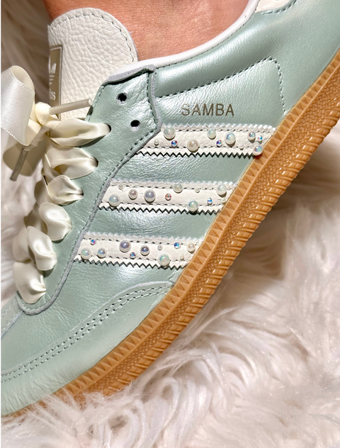 Close-up of hand-placed Swarovski crystals and pearls on the iconic Adidas Samba stripes with a gum sole.