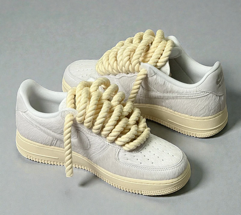 A dynamic shot of Faux Fur Air Force 1s showing the thick texture of 1.0 pastel yellow rope laces and a cream sole.