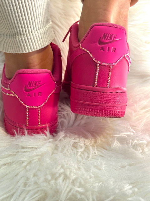 Rear view of custom hot pink Nike Air Force 1s showing the "Nike Air" logo and crystal detailing along the heel seams