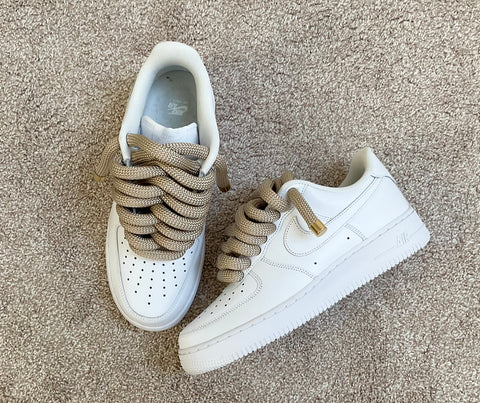 Top-down view of the white Nike Air Force 1 highlighting the symmetrical lacing of the 2.0 gold rope laces.
