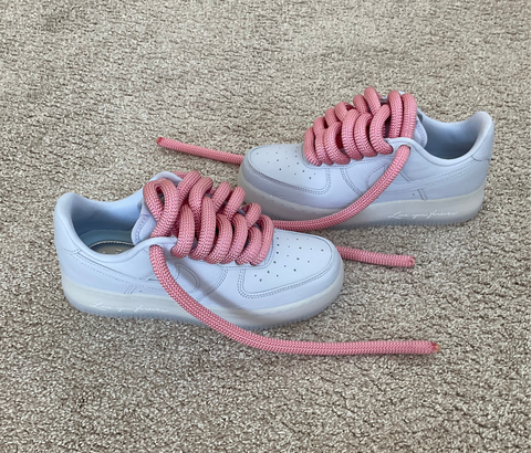 Side profile of sky blue Nike Air Force 1 Drake Nocta customs with 2.0 upgraded light pink waterproof rope laces.