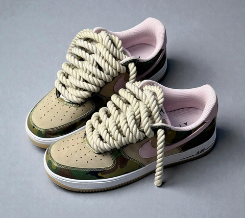 Frontal studio shot of Camo AF1s, emphasizing the symmetrical aesthetic of the 1.0 beige 100% cotton rope laces.
